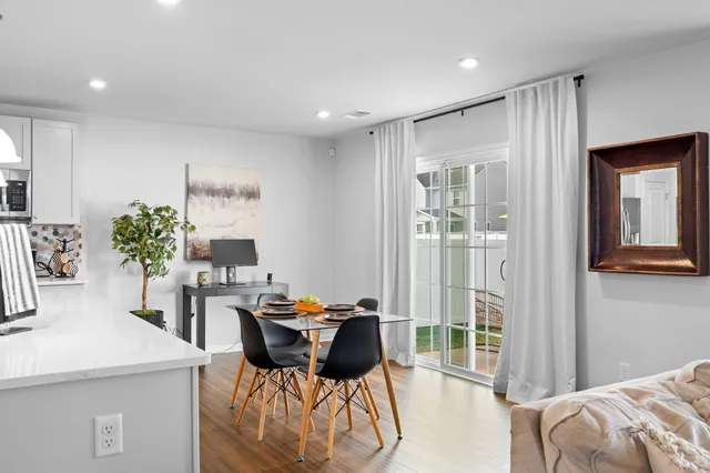 a view of a dining room with furniture and a potted plant