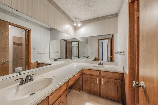 a bathroom with a double vanity sink and mirror