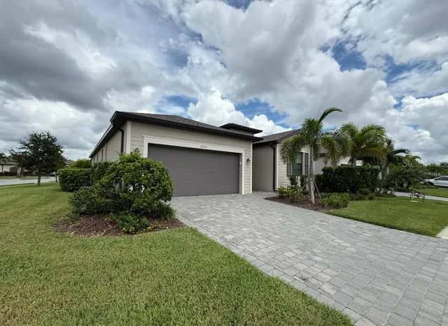 a house with green field in front of it