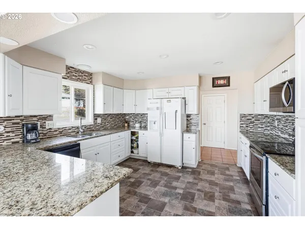 a kitchen with a refrigerator and a sink