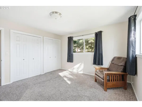 a bedroom with furniture and a window