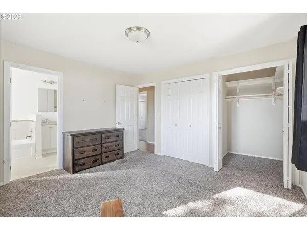 a view of a bedroom with furniture and closet