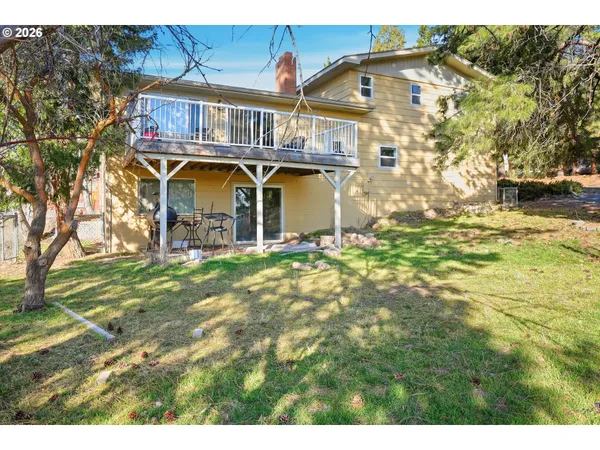 a backyard of a house with large trees