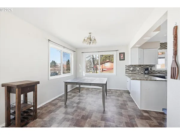 a open kitchen with granite countertop a sink cabinets and wooden floor