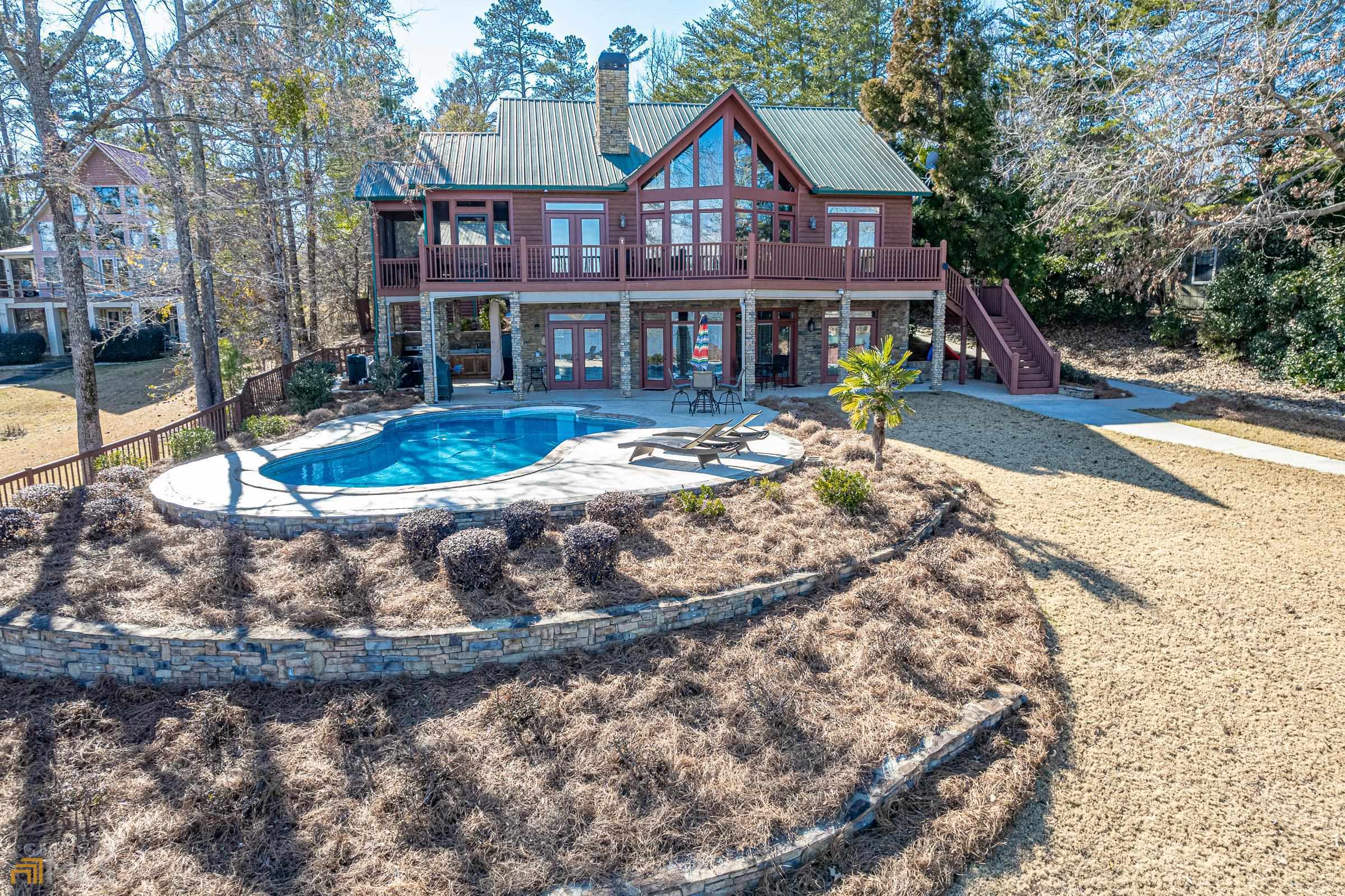 430 South Steel Bridge Road Eatonton, GA 31024 - Photo 1 of 1 a view of a white house with a yard and sitting area