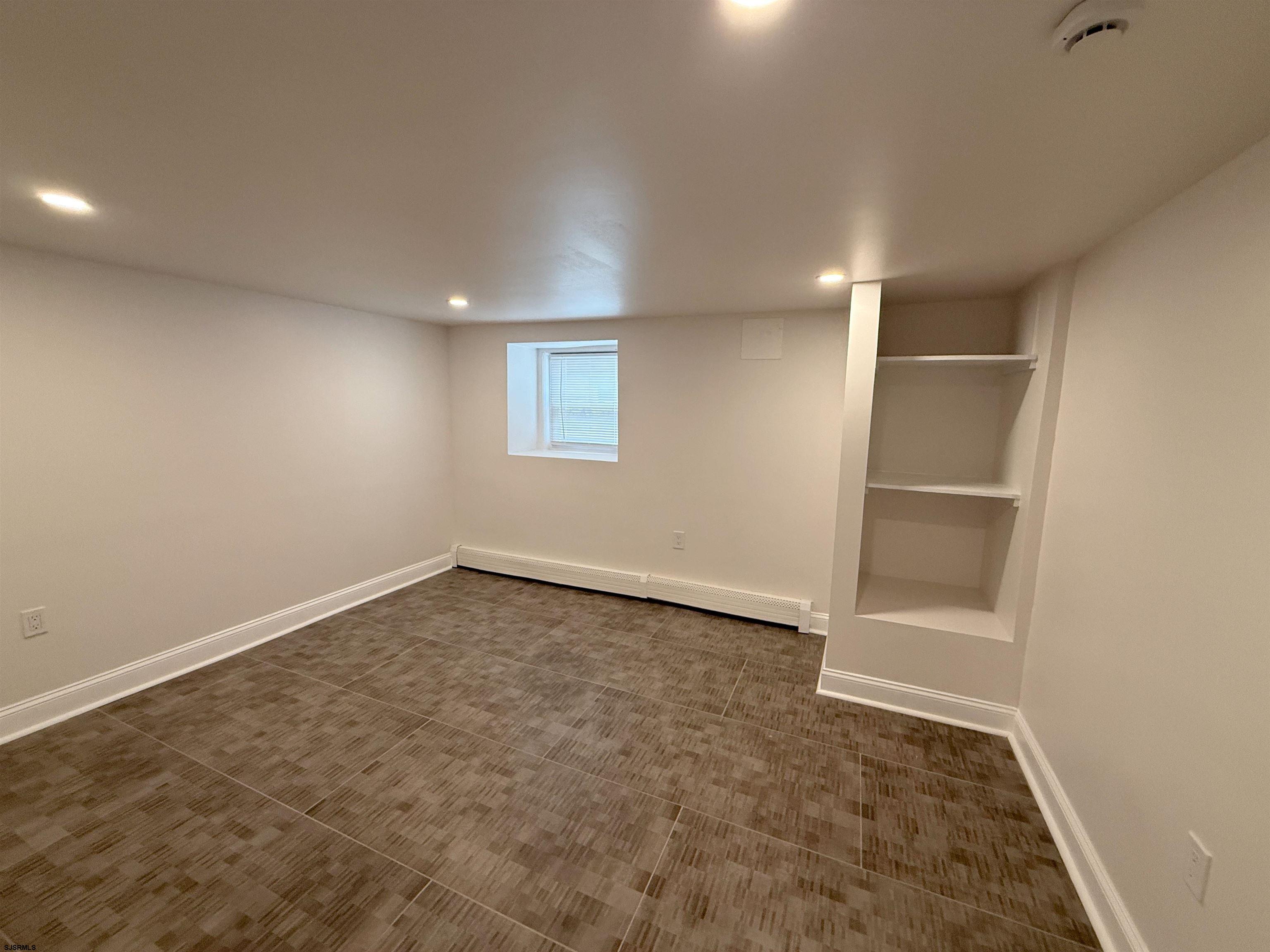 102 South Raleigh Avenue, Unit B Atlantic City, NJ 08401 - Photo 11 of 18 an empty room with a empty space and windows