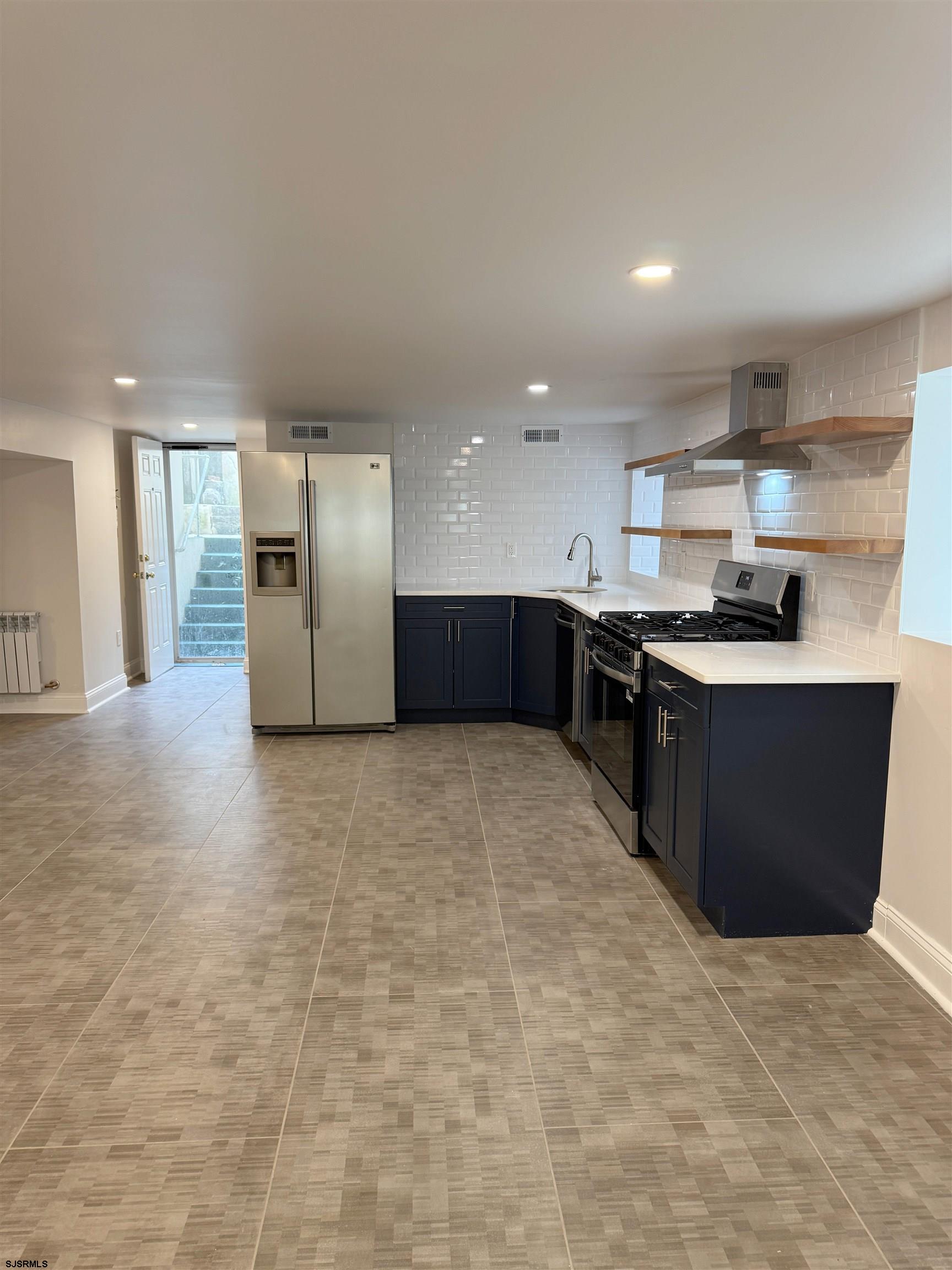 102 South Raleigh Avenue, Unit B Atlantic City, NJ 08401 - Photo 3 of 18 a kitchen with stainless steel appliances granite countertop a stove a sink a refrigerator and a cabinets
