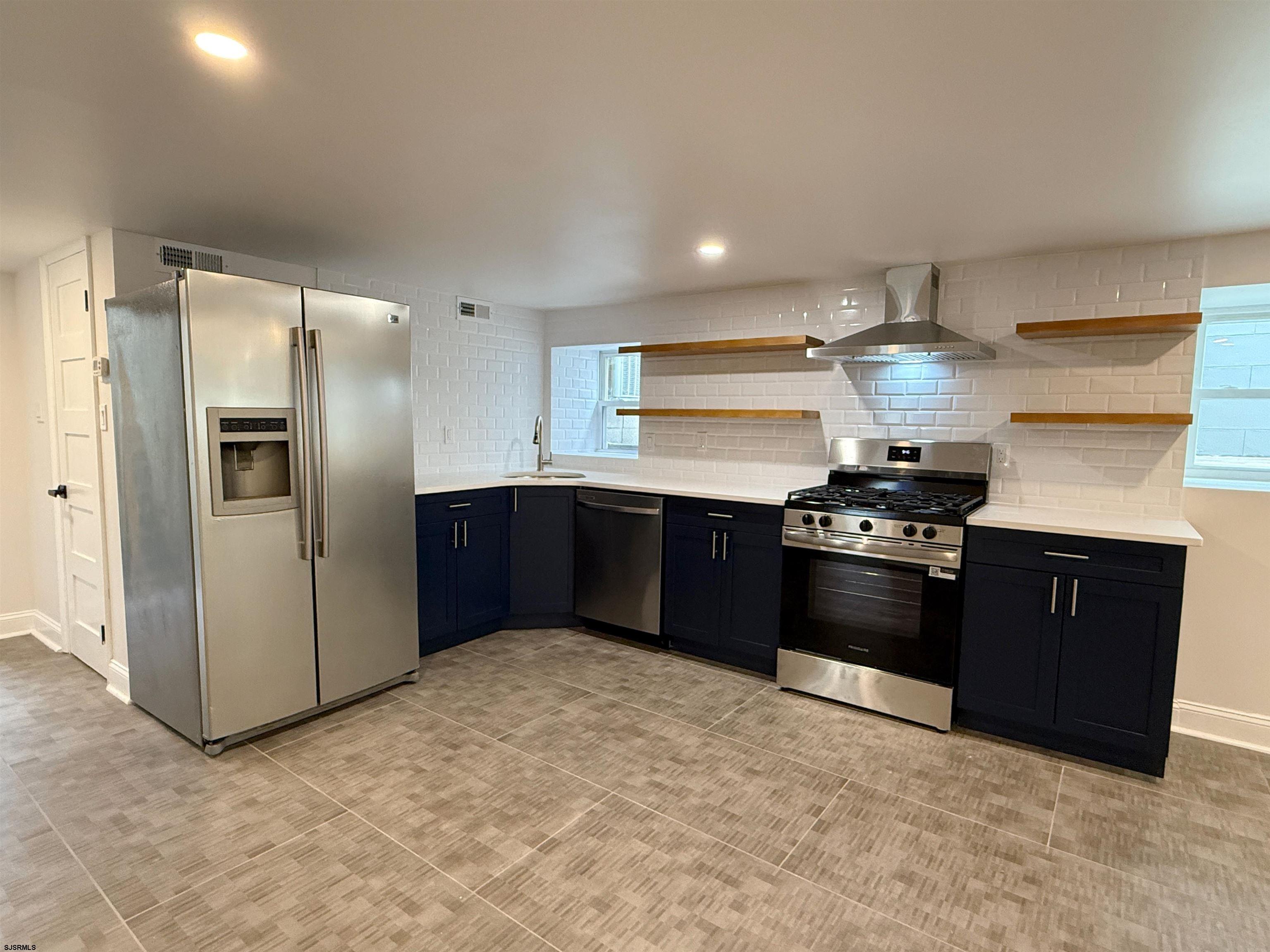 102 South Raleigh Avenue, Unit B Atlantic City, NJ 08401 - Photo 4 of 18 a kitchen with stainless steel appliances granite countertop a stove a refrigerator and a sink