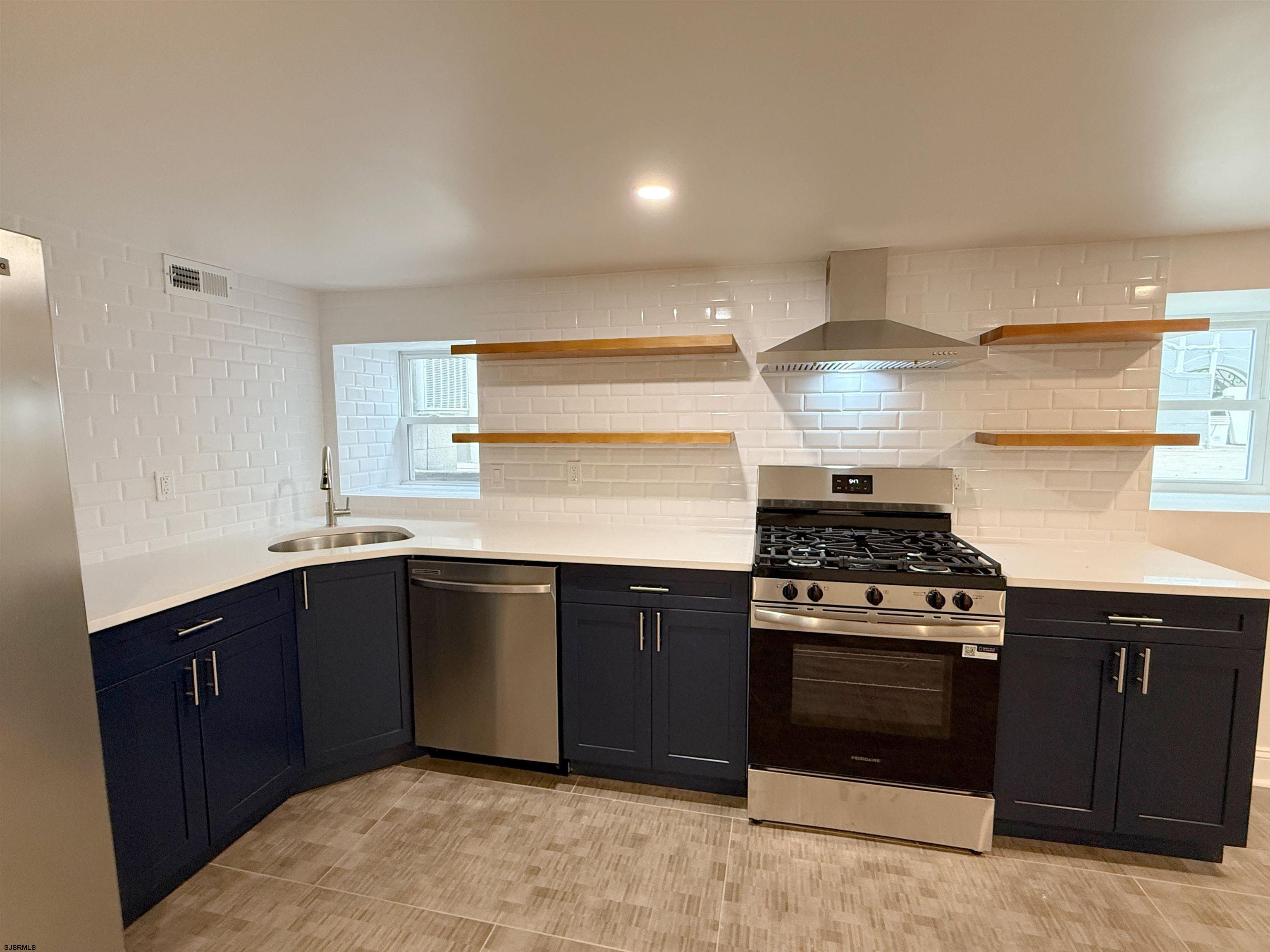 102 South Raleigh Avenue, Unit B Atlantic City, NJ 08401 - Photo 5 of 18 a kitchen with stainless steel appliances granite countertop a stove and a sink