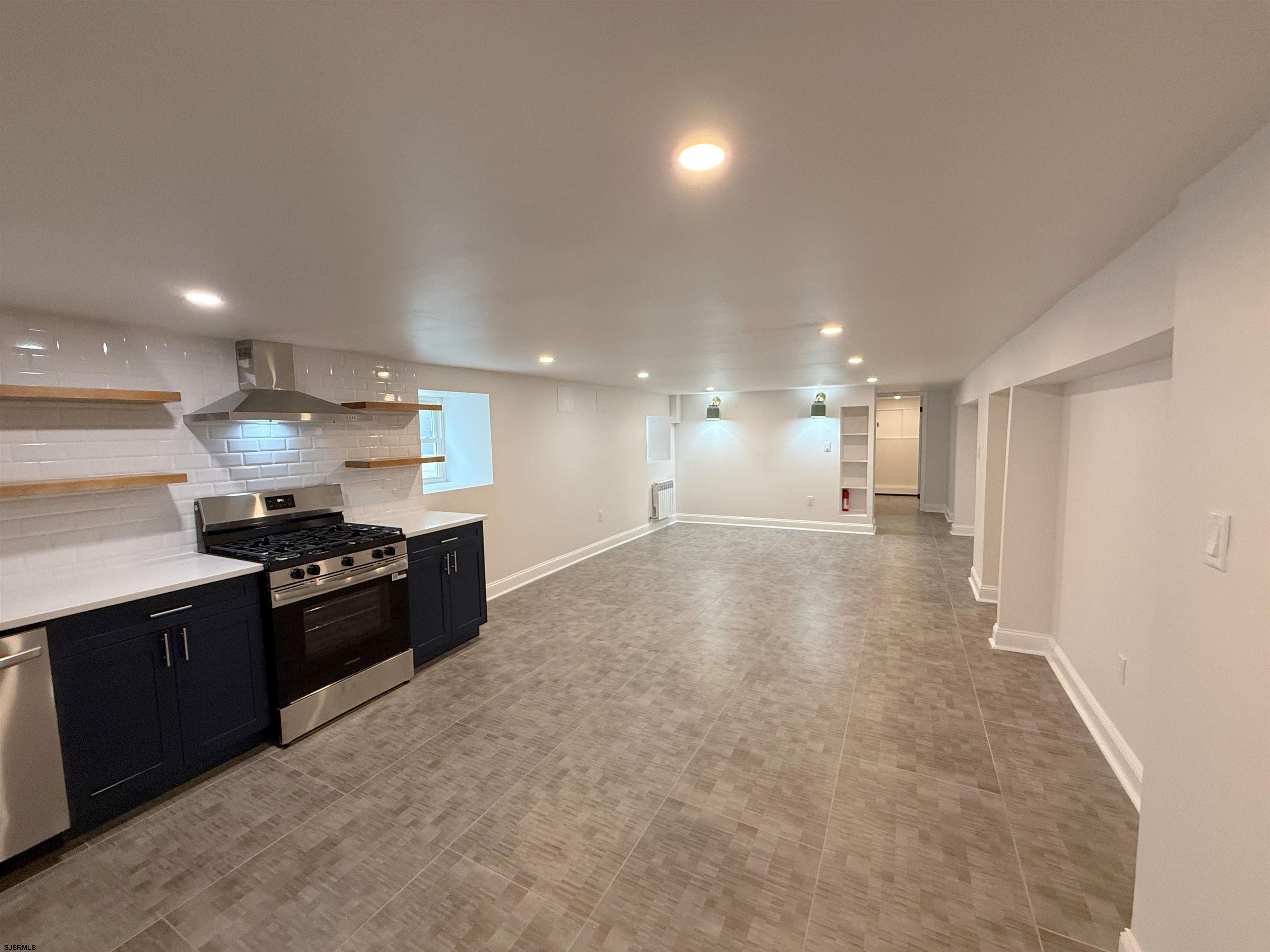 102 South Raleigh Avenue, Unit B Atlantic City, NJ 08401 - Photo 6 of 18 a large kitchen with stainless steel appliances granite countertop a lot of counter space and a sink