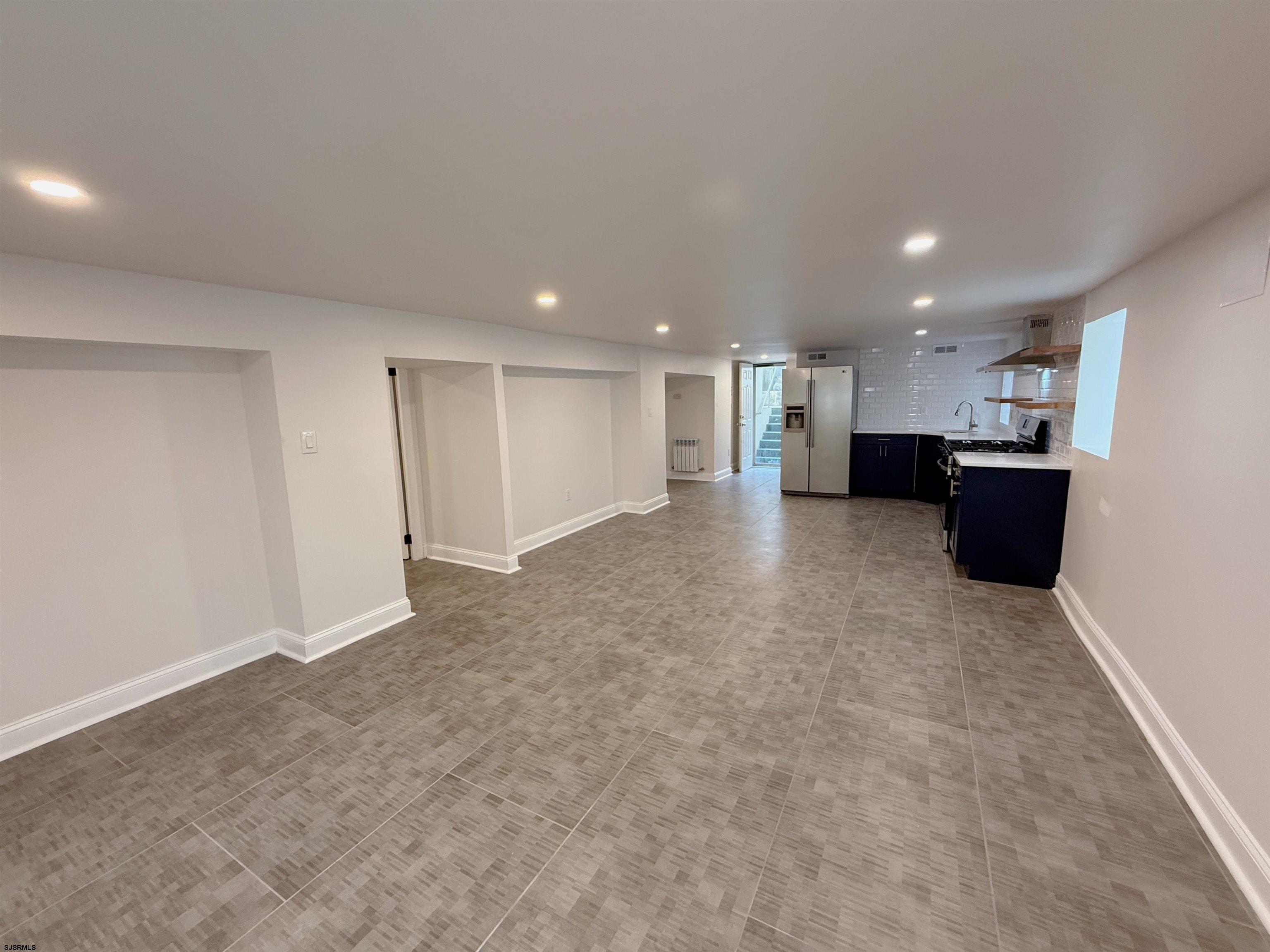 102 South Raleigh Avenue, Unit B Atlantic City, NJ 08401 - Photo 7 of 18 a view of a big room with stainless steel appliances kitchen island refrigerator sink and cabinets