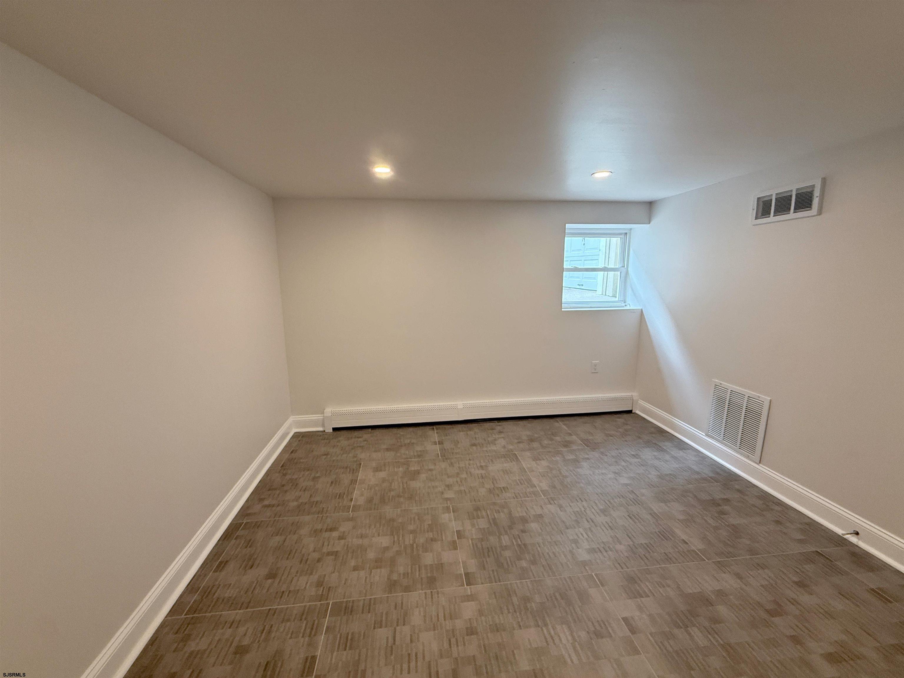 102 South Raleigh Avenue, Unit B Atlantic City, NJ 08401 - Photo 8 of 18 an empty room with a workbench