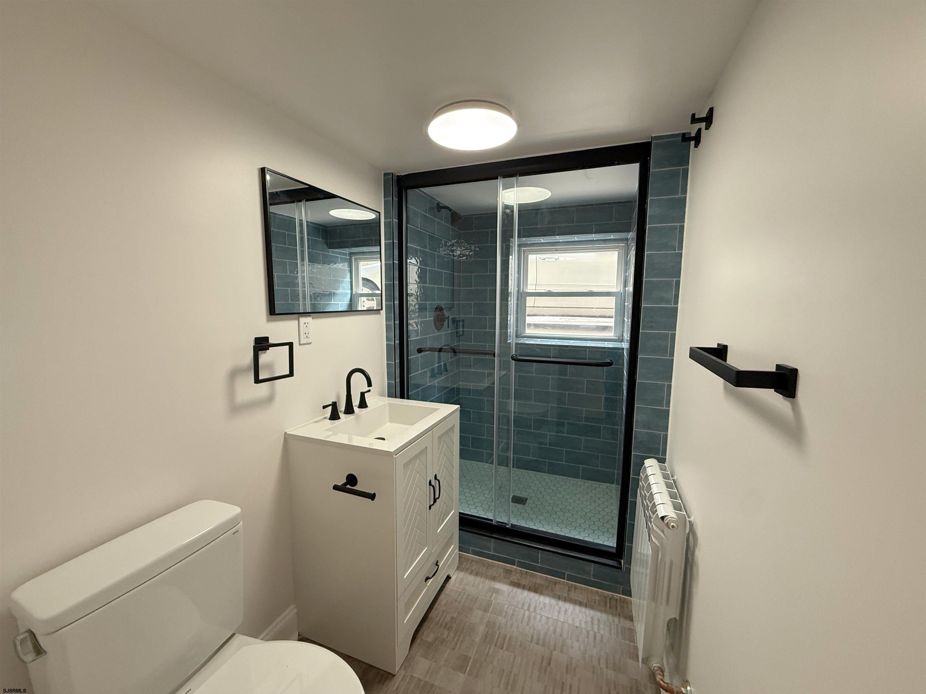 102 South Raleigh Avenue, Unit B Atlantic City, NJ 08401 - Photo 10 of 18 a bathroom with a sink mirror toilet and shower