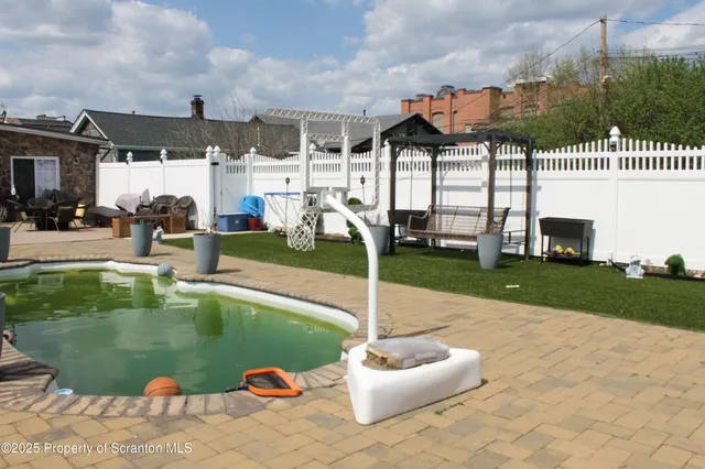 a view of a swimming pool with a patio