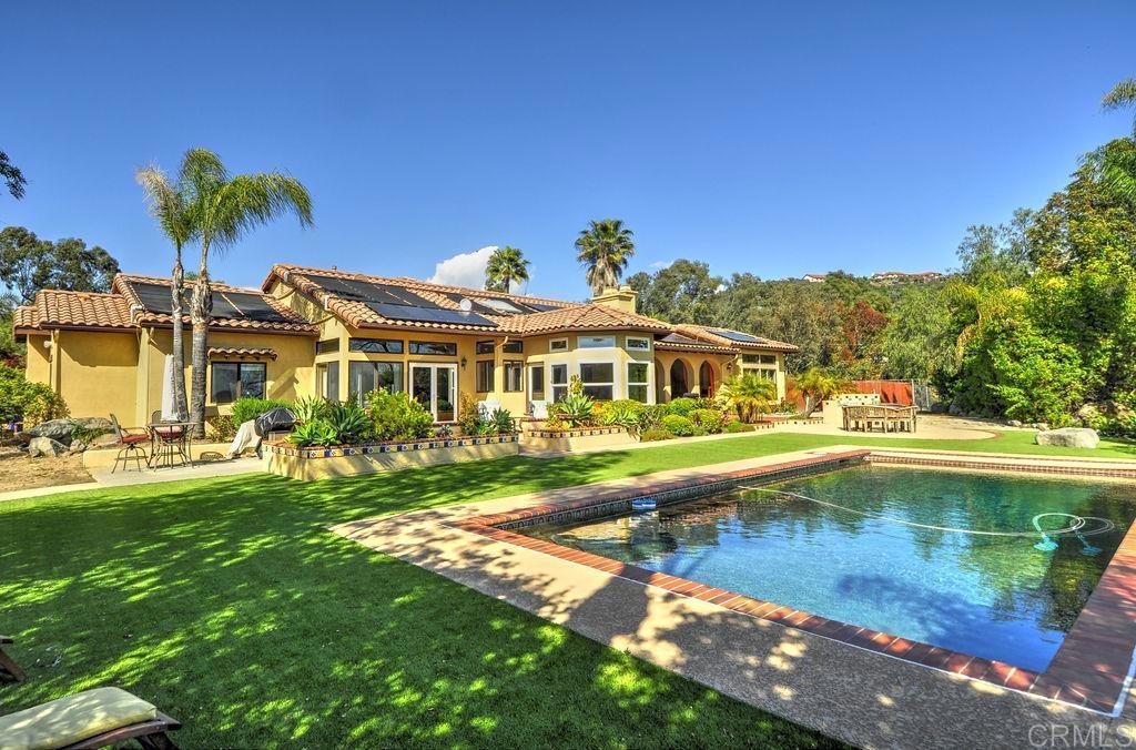 a view of swimming pool with outdoor seating and a yard