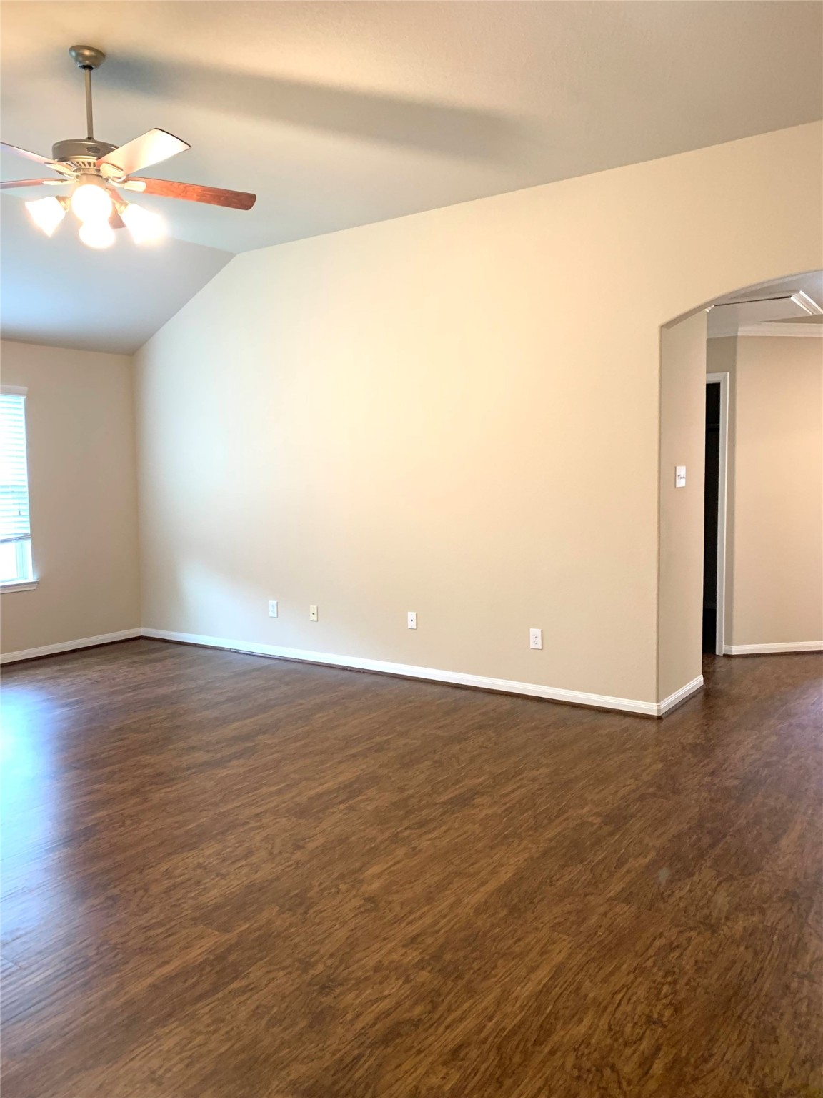 12402 Ridgecrest Drive Willis, TX 77318 - Photo 6 of 11 a view of an empty room with wooden floor and a window