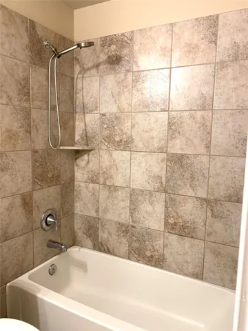 a bathroom with a bathtub and shower