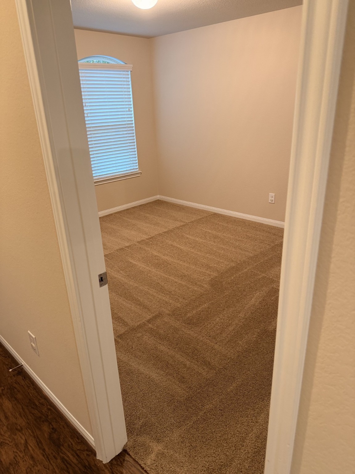 12402 Ridgecrest Drive Willis, TX 77318 - Photo 8 of 11 an empty room with a wooden door