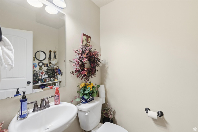 1084 South 740 East Logan, UT 84321 - Photo 14 of 23 Half bathroom featuring a sink and toilet