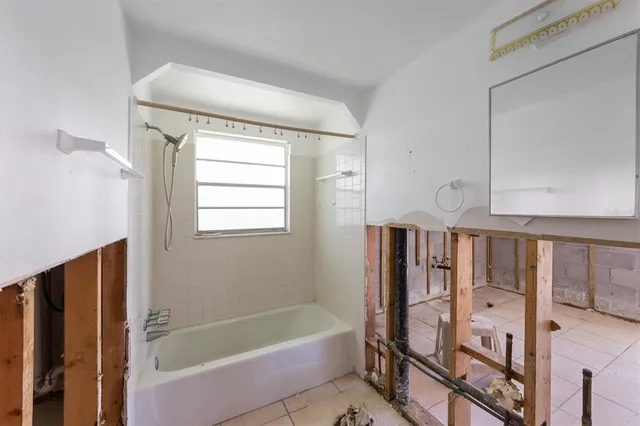 a bathroom with a bathtub and a shower