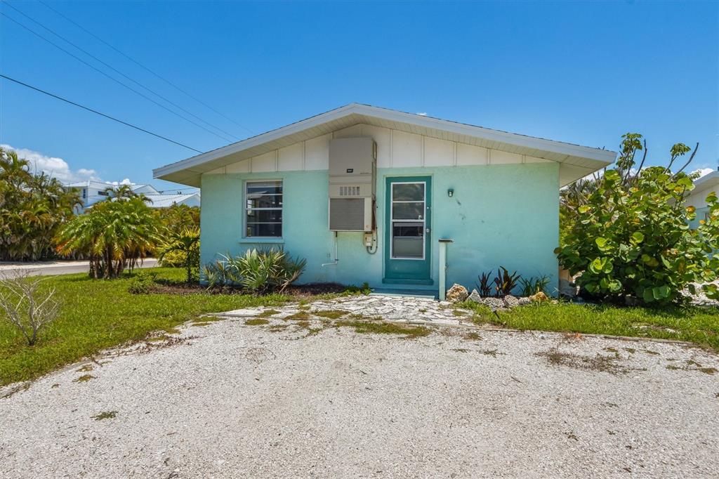 411 Alamanda Road Anna Maria, FL 34216 - Photo 27 of 41 a view of a house with a yard