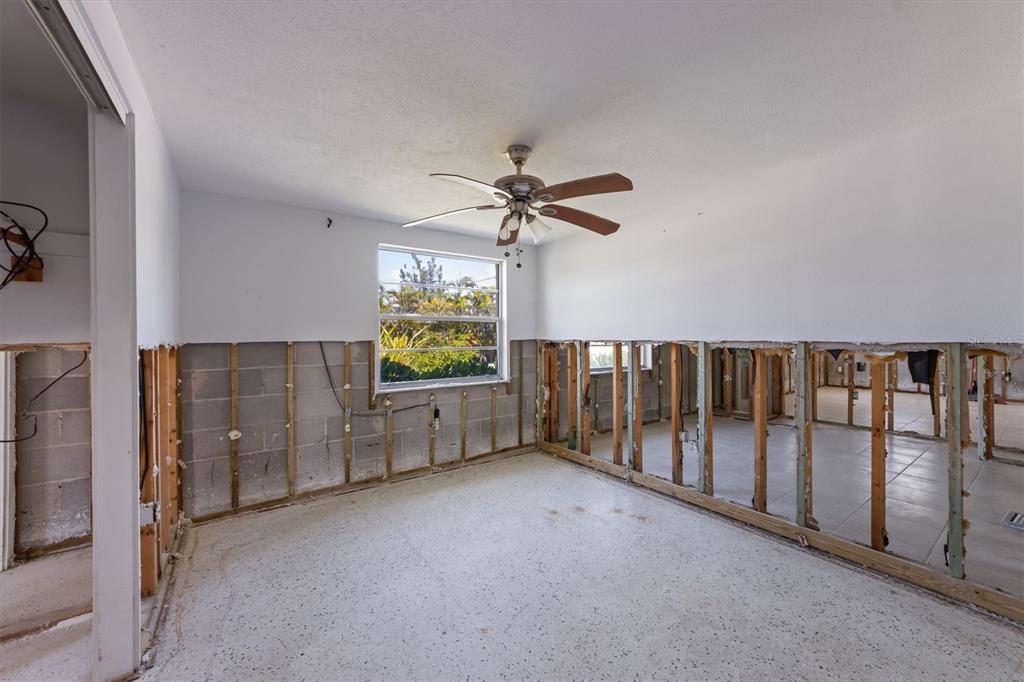 411 Alamanda Road Anna Maria, FL 34216 - Photo 31 of 41 an empty room with windows and fan