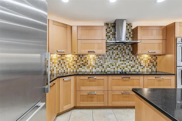 a view of a livingroom with an empty space and a kitchen