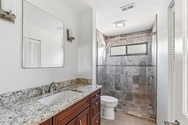 an aerial view of a house with a swimming pool yard and outdoor seating
