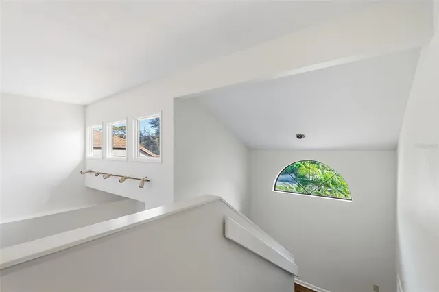 an aerial view of residential houses with outdoor space and trees
