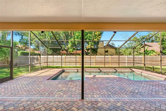 an aerial view of residential houses with outdoor space and parking