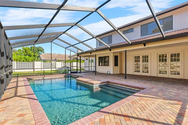 an aerial view of a house with a swimming pool