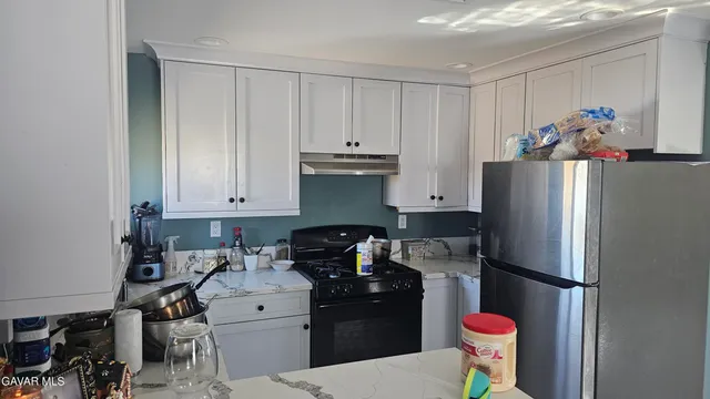 a kitchen with a refrigerator and a stove