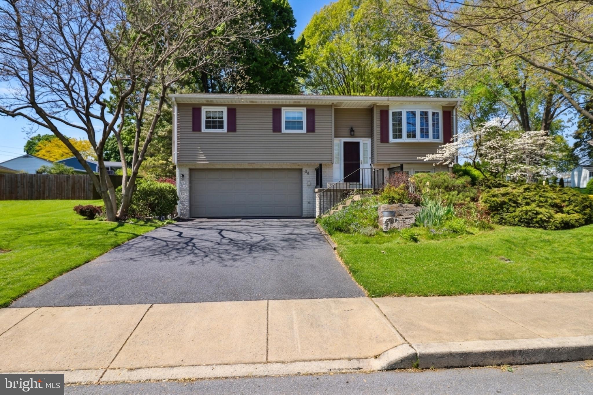 a front view of a house with a yard and a garage