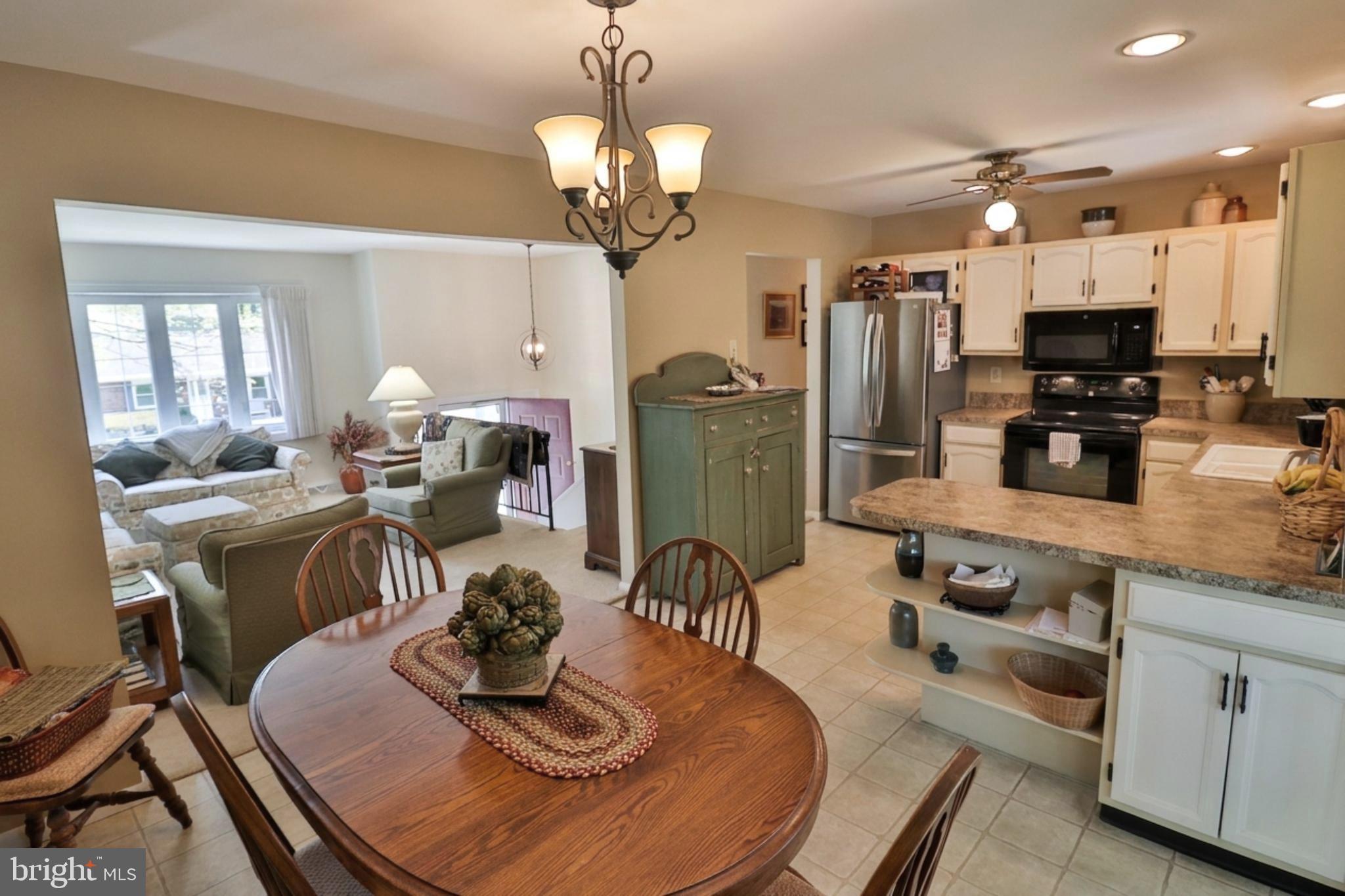 34 South Oak Street Lititz, PA 17543 - Photo 17 of 43 a kitchen with stainless steel appliances granite countertop a sink a stove a dining table and chairs