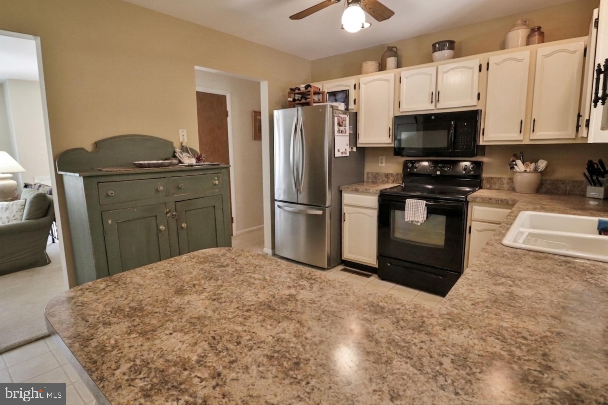 34 South Oak Street Lititz, PA 17543 - Photo 19 of 43 a kitchen with stainless steel appliances granite countertop a refrigerator stove and microwave