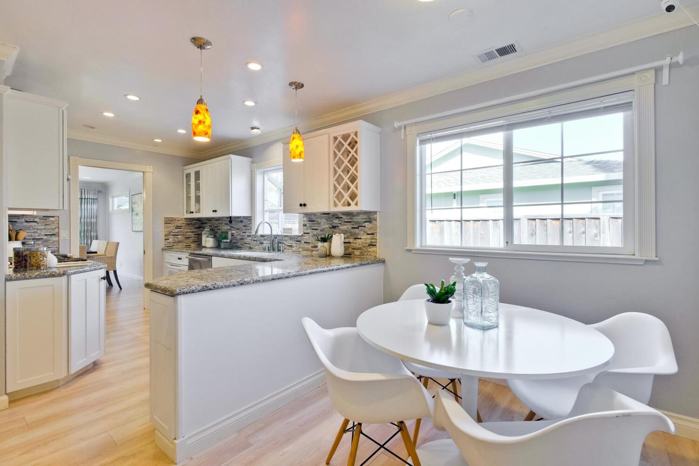 735 Widget Drive San Jose, CA 95117 - Photo 13 of 48 a kitchen with stainless steel appliances granite countertop a stove a kitchen island a table and chairs