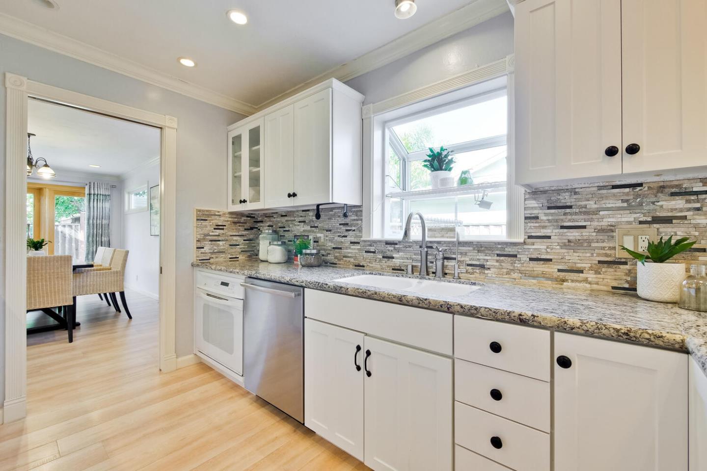 735 Widget Drive San Jose, CA 95117 - Photo 17 of 48 a kitchen with granite countertop cabinets a sink a window and stainless steel appliances