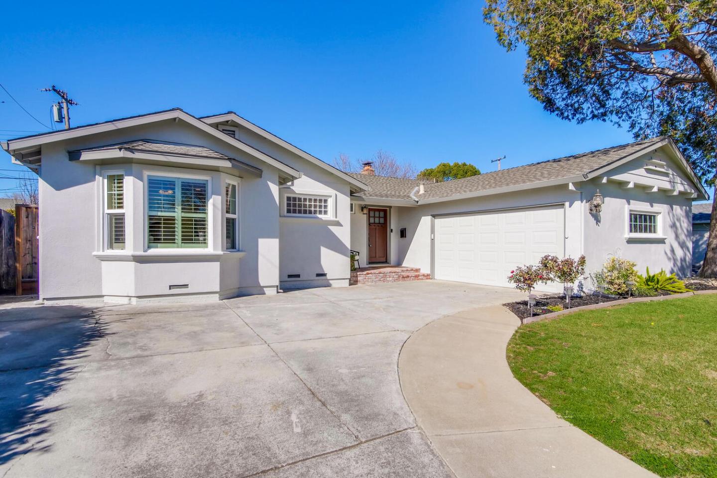 735 Widget Drive San Jose, CA 95117 - Photo 2 of 48 a front view of a house with a yard and garage