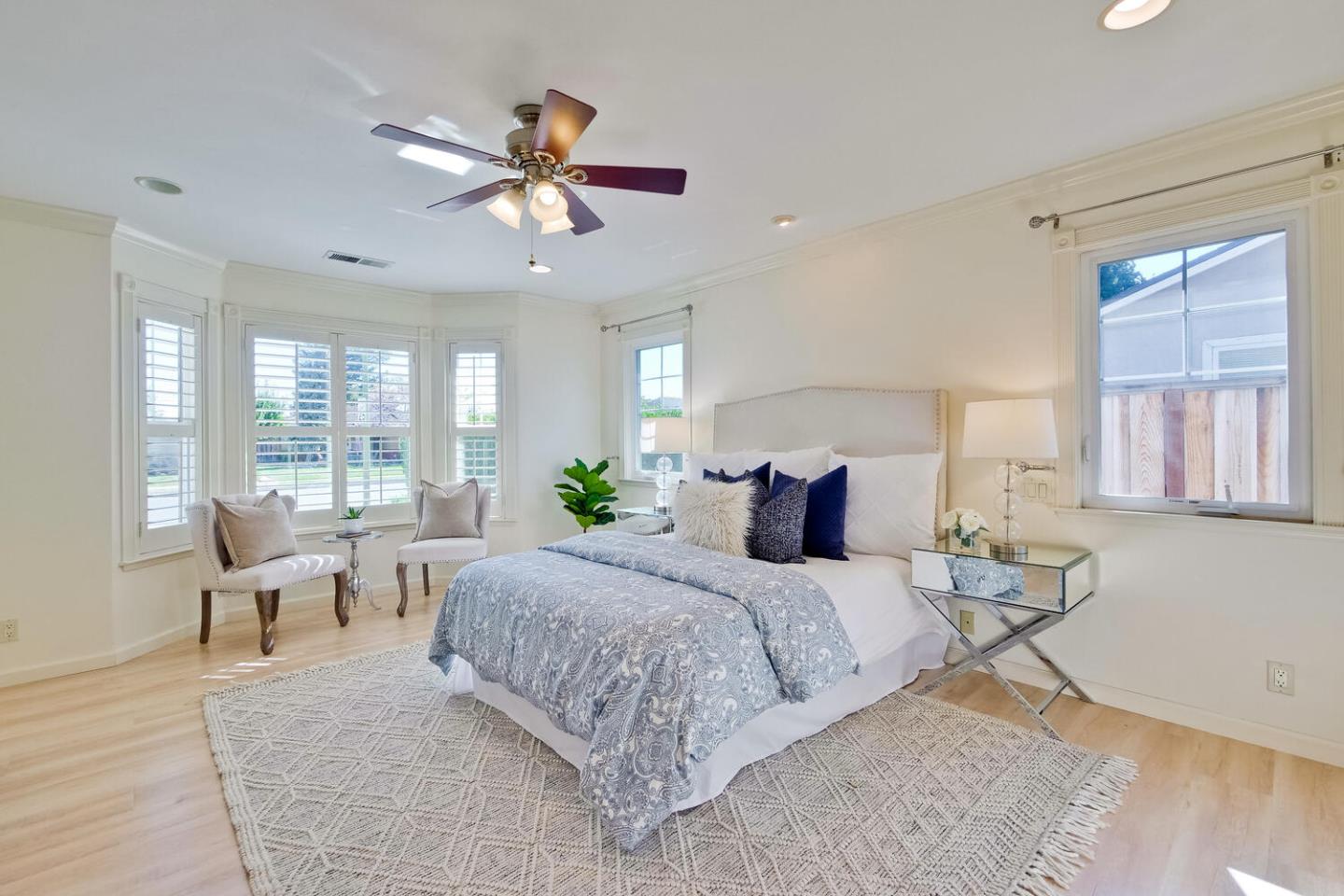 735 Widget Drive San Jose, CA 95117 - Photo 23 of 48 a bedroom with a large bed and a chandelier