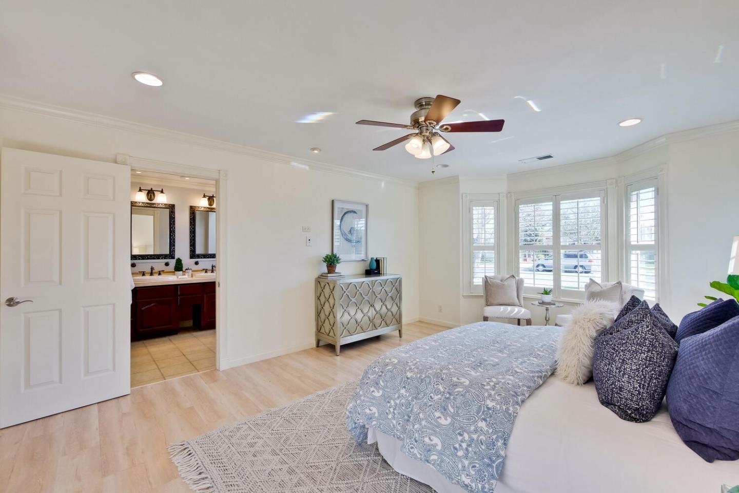 735 Widget Drive San Jose, CA 95117 - Photo 24 of 48 a spacious bedroom with a large bed and a chandelier