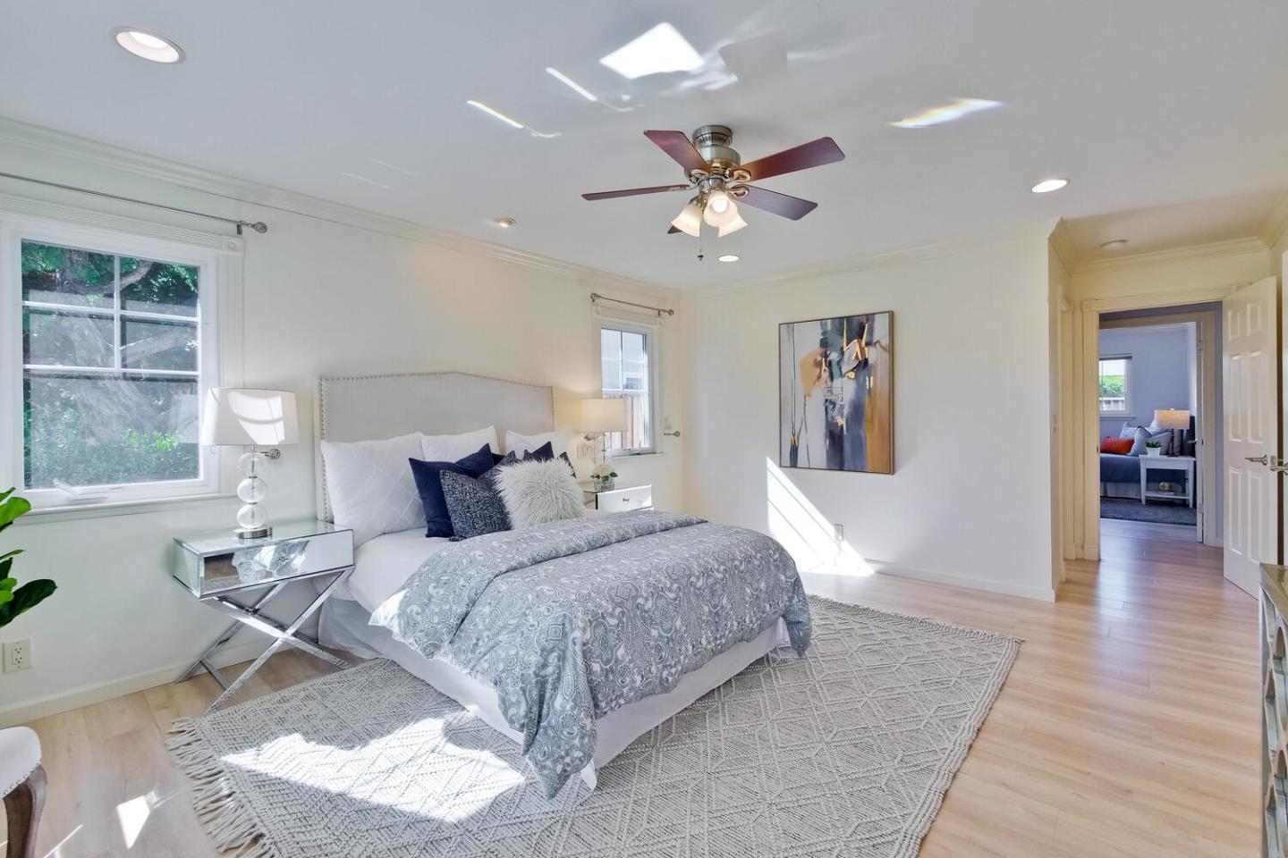 735 Widget Drive San Jose, CA 95117 - Photo 25 of 48 a spacious bedroom with a large bed and a chandelier