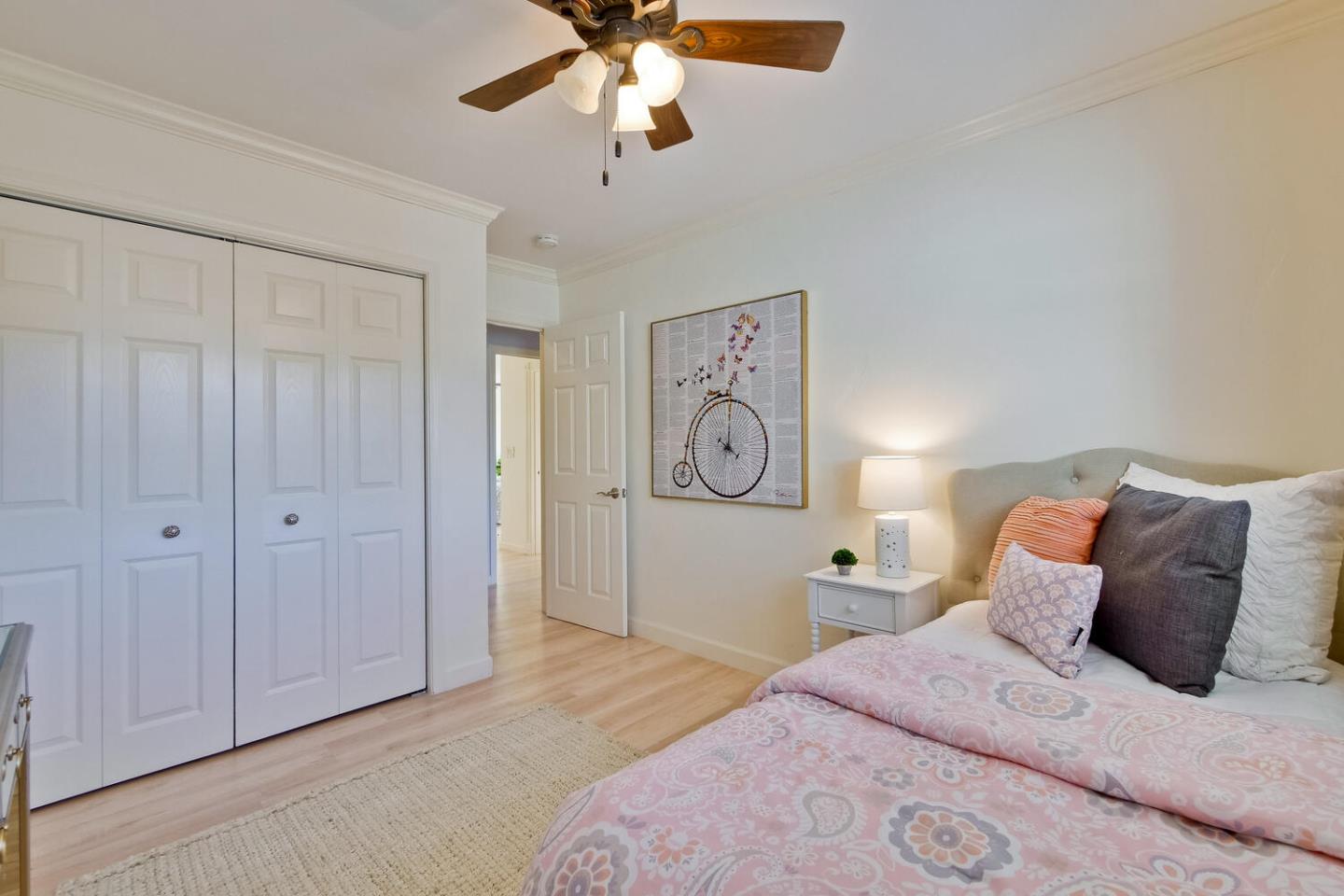 735 Widget Drive San Jose, CA 95117 - Photo 37 of 48 a bedroom with a bed and a chandelier