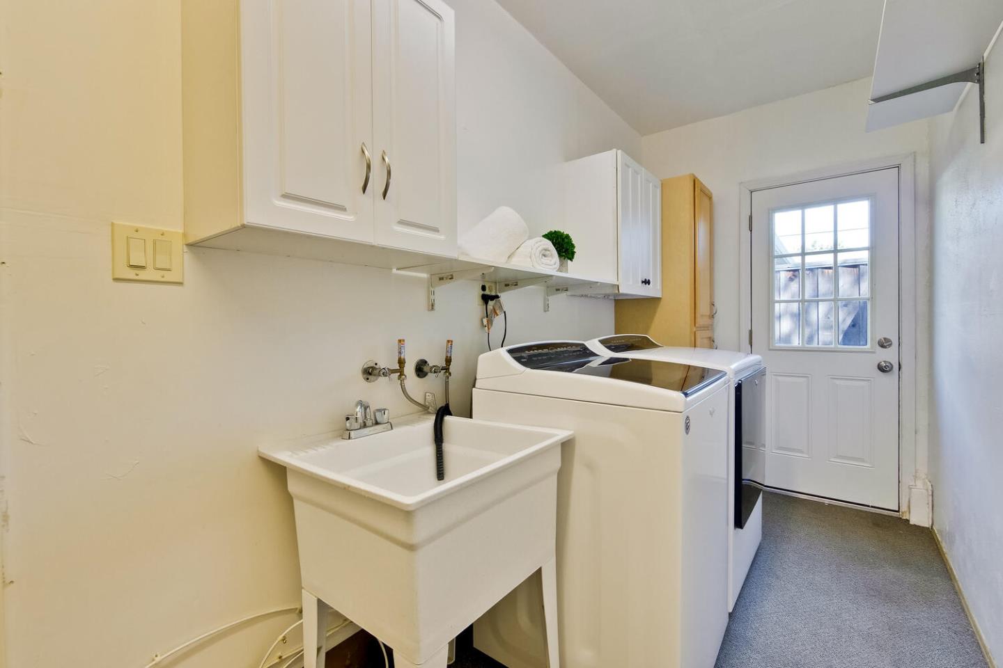 735 Widget Drive San Jose, CA 95117 - Photo 41 of 48 a kitchen with a sink a stove and cabinets