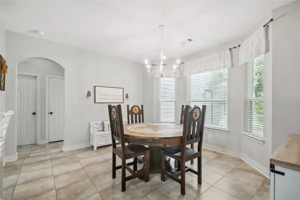 a view of a dining room with furniture large window and chandelier
