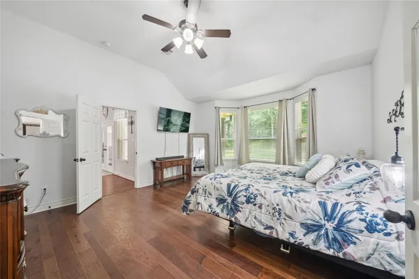 a bedroom with a large bed and a chandelier