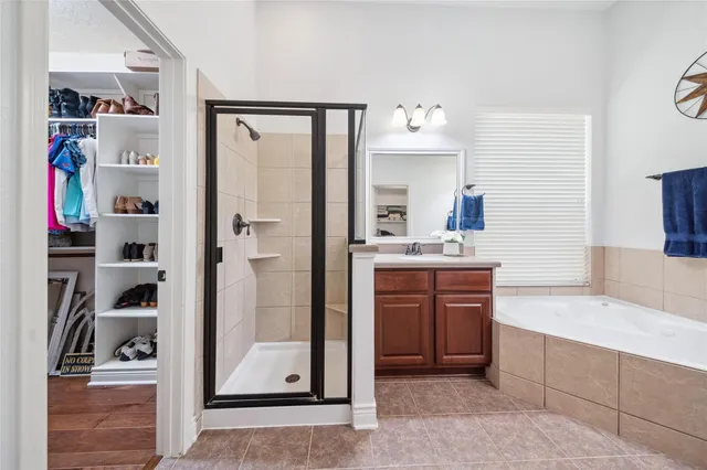 a bathroom with a tub sink and mirror