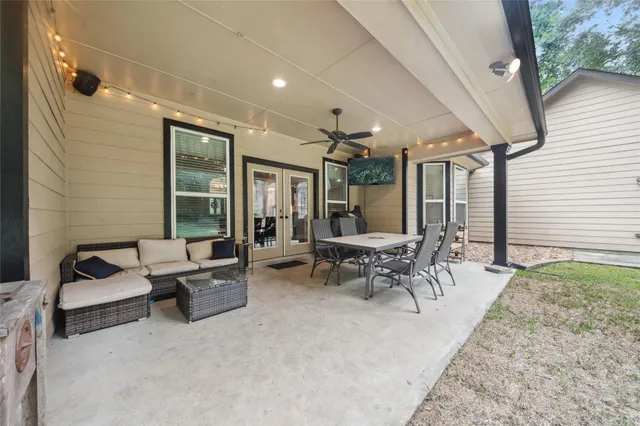 a patio with patio couch and outdoor seating