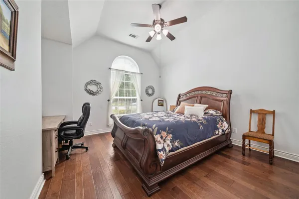 a bedroom with a bed a desk and chair