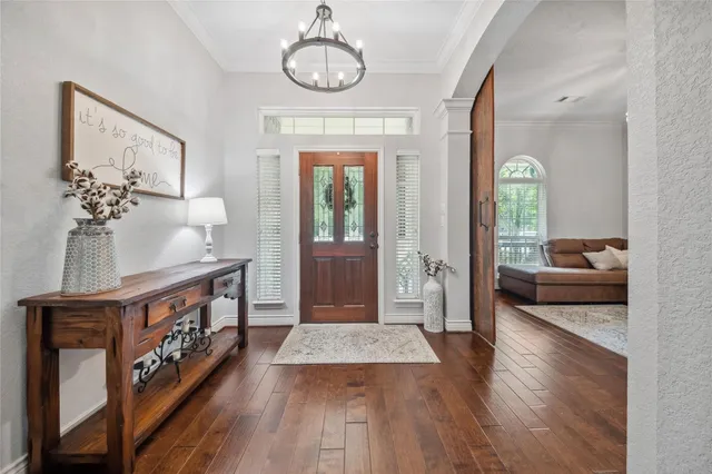 a view of a hallway view with wooden floor and staircase