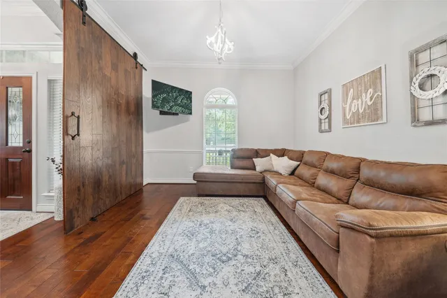 a living room with furniture and a chandelier